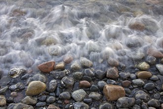 Pebbles on beach in the surf at low tide, Germany, Europe