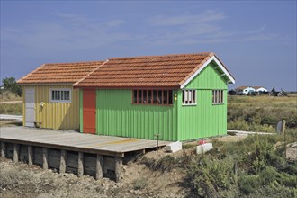 Colourful cabins of oyster farm at la Baudissière near Dolus, Saint-Pierre-d'Oléron on the island