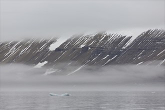 Mountains in the fog along the coast at Hinlopenstretet, Hinlopenstreet, Hinlopen strait between