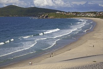 Tourists walking along One Mile Beach at Forster, New South Wales, Australia, Oceania