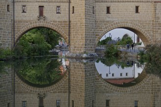 Clear reflection of the fortification wall in the river Vils, Amberg, Upper Palatinate, Bavaria,