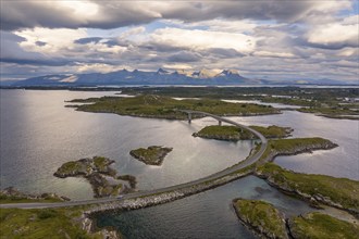 Road over small islands, behind the mountain Seven Sisters, Herøy island, Helgeland coast,