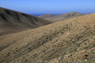 Bare moon-like arid landscape in mountains between Pajara and La Pared, Fuerteventura, Canary