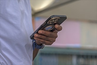 Hand of a coloured woman with an Iphone, Genoa, Italy, Europe