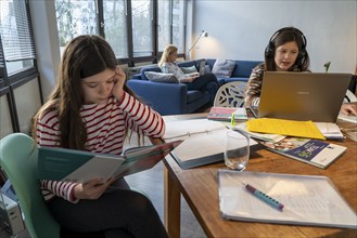 Homeschooling, during the lockdown in January 2021, children learning at home for school, a girl in