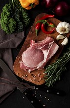 Raw pork meat, on a wooden board, close-up, vertical, no people, selective focus, rustic, serving,