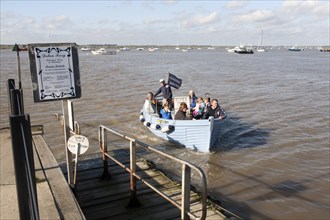 Small ferry boat crossing River Deben between Felixstowe Ferry and Bawdsey Quay, Suffolk, England,