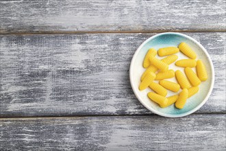 Jelly corn candies on gray wooden background. top view, flat lay, copy space