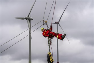 Height rescuers from the Oberhausen fire brigade practise abseiling from a wind turbine from a