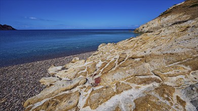 Rocky coast with turquoise water and blue sky, Lambi beach, pebble beach, Patmos, Dodecanese, Greek