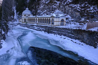 Büvetta Tarasp drinking hall on the Inn or En, Nairs near Scuol in winter, with ice floes, Engadin,