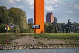 The sculpture Rhine Orange at the mouth of the Ruhr into the Rhine, skyline of the city centre of