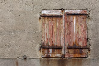 Window with dilapidated shutters and rusty iron fittings, Roscoff, Finistère, Brittany, France,