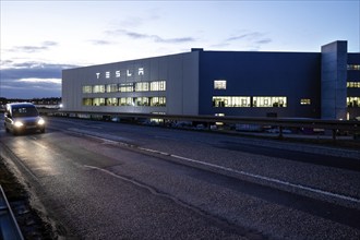 A car drives past the battery factory of the Tesla plant, Grünheide, 13.01.2023