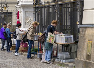 Tourists at the flea market stall in front of Humboldt University, Unter den Linden, Berlin,