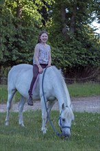 Girl, 10 years old on her horse, Othenstorf, Mecklenburg-Vorpommern, Germany, Europe