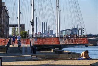 Cyclists on the Cirkelbroen cycle and pedestrian bridge, over the harbour, in the Christianshavens