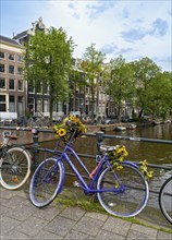 Bicycle on a bridge over Singel canal, Amsterdam, Netherlands