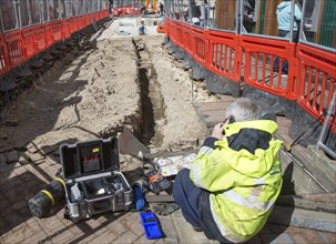 Male BT Openreach broadband technician working in town centre of Ipswich, Suffolk, England, UK