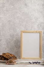 White wooden frame mockup with lavender in ceramic vase, linen textile, cup of coffee and bun on