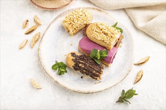 Set of eclair, traditional french dessert and cup of coffee on gray concrete background and linen