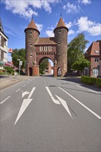 Historic city gate Lüdinghauser Tor against blue sky with cumulus clouds and Lüdinghauser Strasse