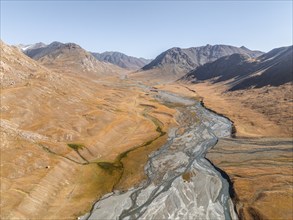 Aerial view, Burkhan mountain valley with meandering river, barren dramatic mountain landscape,