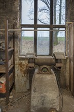 Old grinding machine in a former LPG workshop in the GDR, Mecklenburg-Vorpommern, Germany, Europe