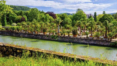 Castle moat with palm garden in the spa gardens, the largest outdoor palm garden north of the Alps,