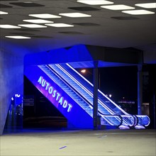 Illuminated escalator to the Autostadt under the phæno building at night, Wolfsburg, Lower Saxony,