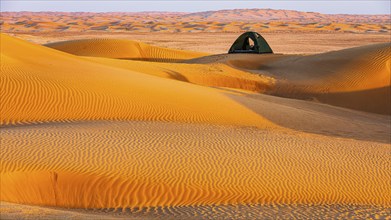 Wind-sculpted sand structure, tent in the sand dunes, in the Rub al Khali desert, Dhofar province,