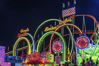 Illuminated ride XXL-Racer, behind the illuminated Olympia five-loop, night shot, Oktoberfest,