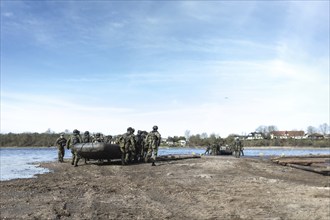 Czech soldiers launch an inflatable boat for a water crossing as part of the military exercise