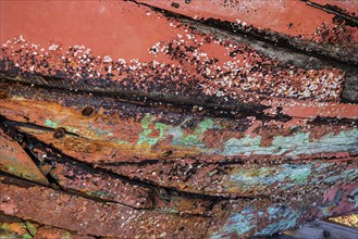 Colourful ship's planks, rotten hull and old planks of a ship, close-up of the underwater hull.