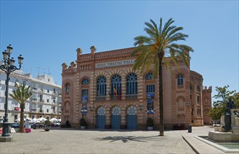 A red historic building on a town square with palm trees, Gran Teatro Falla, theatre, old town,