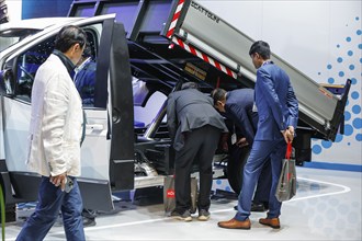 Trade fair visitors take a look at the eMoovy electric commercial vehicle developed by Hyundai