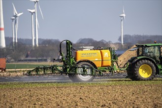 Wind turbine, near Kerken, Kleve district, on the Lower Rhine, farmer applies pesticide, North