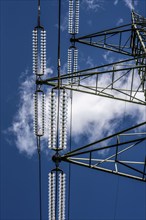 Insulators made of glass on a high-voltage line, they hang on the pylons as a suspension device