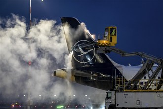 Winter at Frankfurt Main Airport, FRA, Lufthansa aircraft being de-iced by de-icing vehicles,