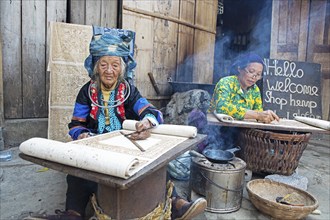 Vietnamese woman from the Hmong minority draw patterns on linen fabric, Lung Tam linen weaving