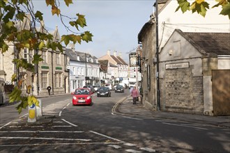 Traffic and historic buildings in the town centre of Melksham, Wiltshire, England, UK