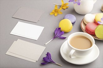 Gray and white business card mockup with spring snowdrop crocus flowers, cup of coffee,