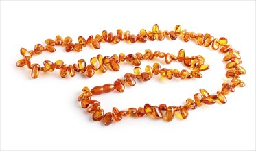 Orange amber beads isolated on white background. top view, close up