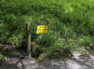 Yellow sign on fence, Bavaria, Germany, Europe