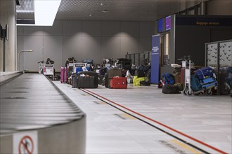 Many lost suitcases and pieces of luggage are ready for collection at an airport