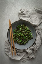 Fried bean pods, in soy sauce, with sesame seeds, homemade, no people