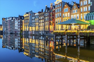 Canal houses on the Damrak, in the centre of the old town of Amsterdam, harbour, starting point of