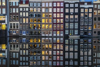 Canal houses on the Damrak, in the centre of the old town of Amsterdam, harbour, starting point of