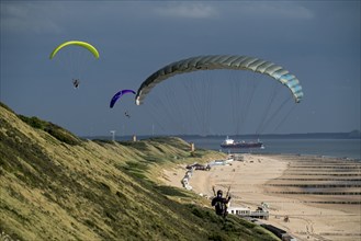 Paragliders along the dunes of Zoutelande, in Zeeland, South Holland, Netherlands