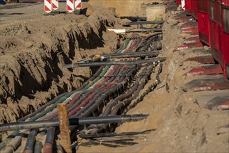 Cables, pipes, next to each other in a construction site, supply lines exposed during construction